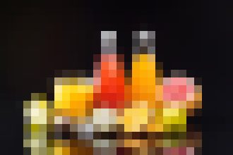 Colorful row of bottles on a dark bar backdrop, suggesting a liquor display.