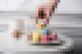 Very pixelated photo of a person indoors; details and surroundings are unclear, identity not discernible.