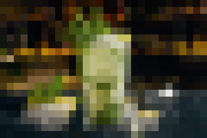 A bottle on a dim bar counter with glasses and warm, blurred lights in the background, suggesting a nightlife scene.