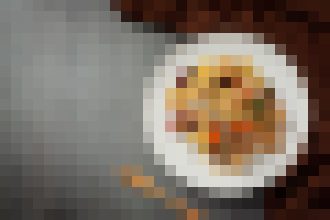 Plate with fried food on a white dish, set on a dark wooden table.
