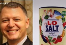 ქართული სამზარეულო და მარილი – რატომ უნდა გადავიდეთ “ლო სალტ-ზე (Lo Salt-ზე)? Smiling man in a suit on the left beside a colorful LO SALT iodized salt can on the right, with fruit and vegetable illustrations.