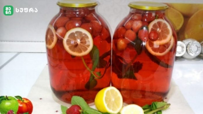 marwyvis mohito Two glass jars of red fruit-infused beverage with lemon slices and berries, on a kitchen counter; front has lemons, limes, berries and mint