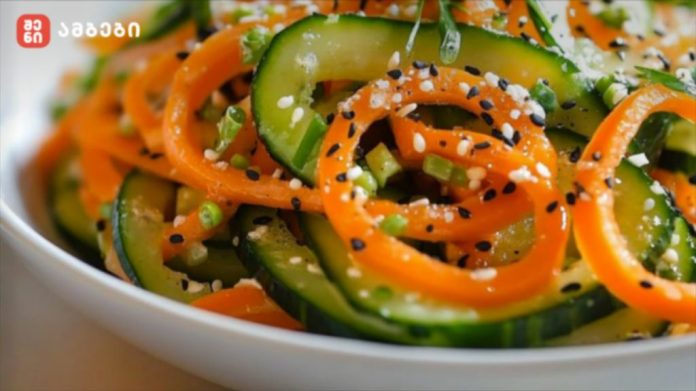 Bowl of cucumber ribbons and carrot spirals sprinkled with sesame seeds, a fresh veggie salad illustration in a white dish.