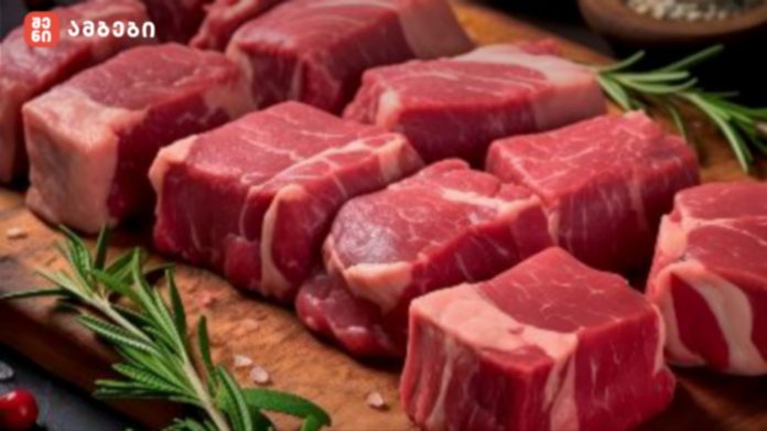 Raw beef cubes on a cutting board with sprigs of rosemary, ready for cooking, with a few salt crystals nearby