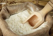 ხორბალი ქართული და გამორჩეული Open burlap sack filled with white flour with a wooden scoop resting inside.