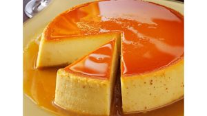torti supra Creamy caramel flan topped with glossy orange caramel sauce, with two slices cut to reveal the smooth custard interior.
