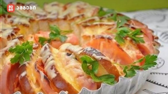 gemrieli Mini tomato and cheese tartlets garnished with parsley on a foil tray in a sunny setting.