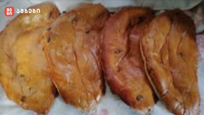 nazuqi Four golden-brown fried pastries arranged in a row on a plate with a floral cloth beneath them.
