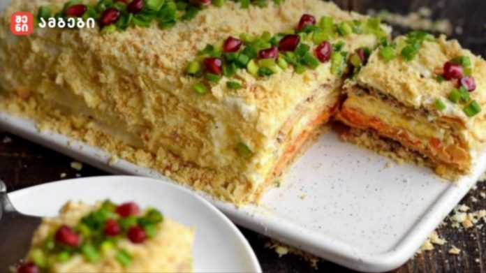 Crumb-topped savory layered cake with green onions and pomegranate seeds, sliced to show filling inside.