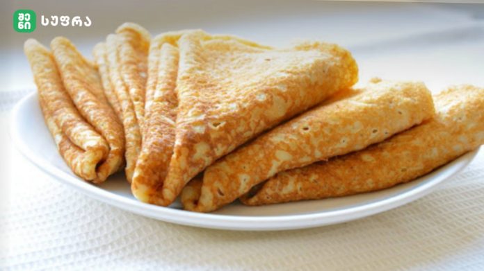Golden-brown fried cheese sticks on a white plate, logo in the top-left corner.
