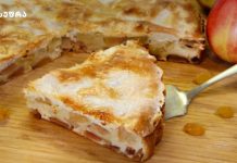 იტალიური ვაშლის პეროგი Sliced apple cake on a wooden cutting board with a few raisins nearby.